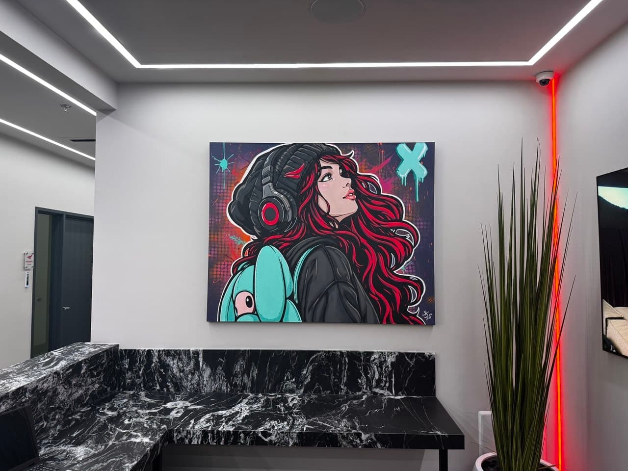 Showroom wall dimmed around a colorful portrait artwork